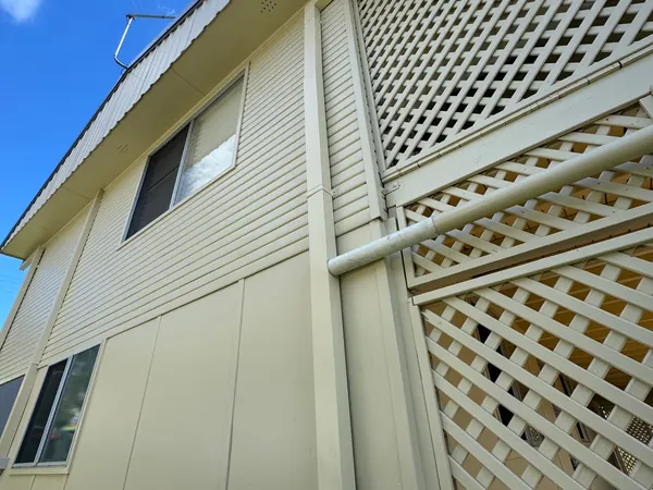 New cream metal fascia, gutter and downpipe on a two storey home